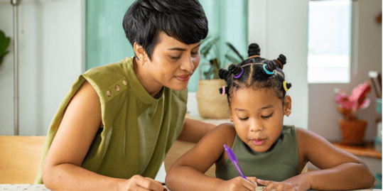 Cute child girl kid studying homeschooling and eating cookie with mom