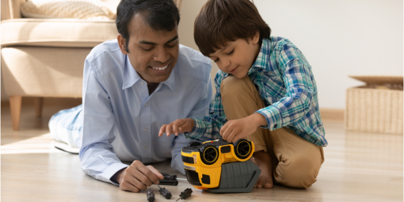 Dad and son playing with a car