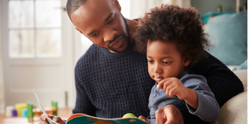 Father and son sharing a book 2