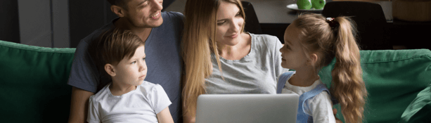 young family talking on sofa during lockdown