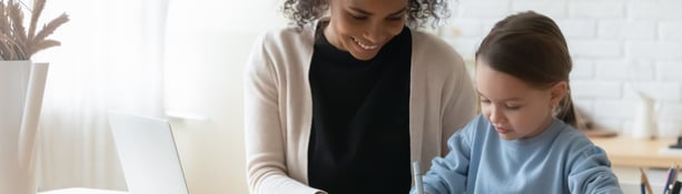 mother helping her daughter with homework task