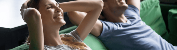 young couple relaxing on sofa young couple relaxing on sofa during lockdown