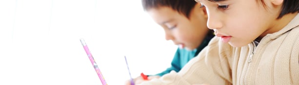 Child Writing in Classroom