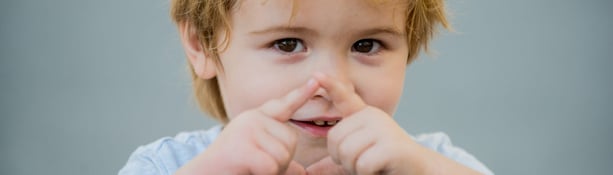 Young boy using makaton signs to communicate