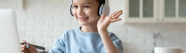 young girl wearing headphones and waving