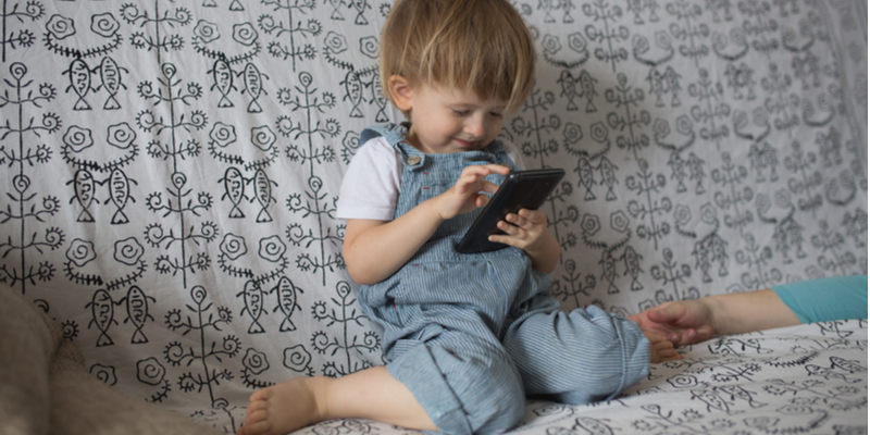 Little boy playing on his phone