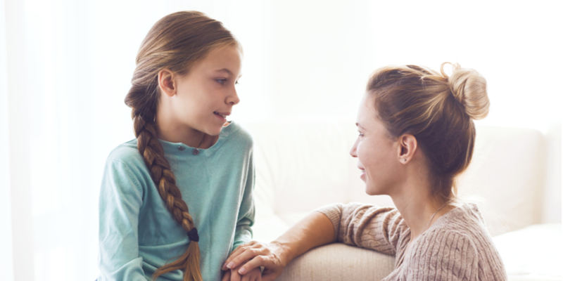 Mom with her pre teen daughter hugging, positive feelings