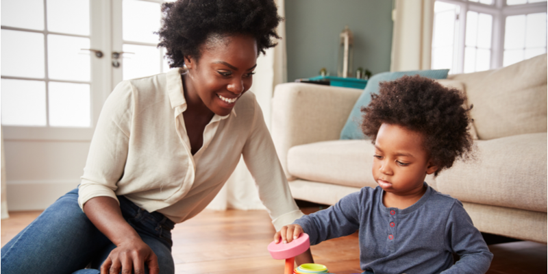 Mum and cute son playing with toys