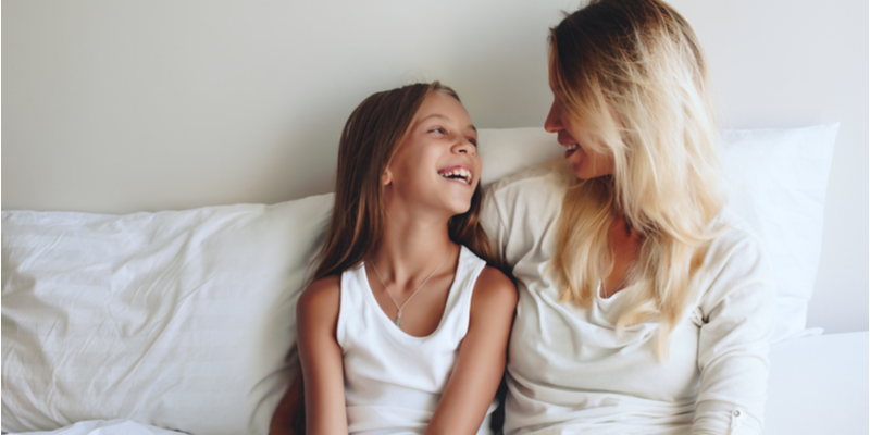 Mum and daughter in bed chatting