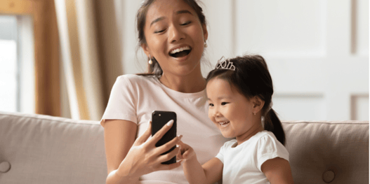 Mum and daughter looking at something on a phone
