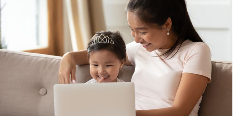 Mum and toddler engaged in speech therapy online