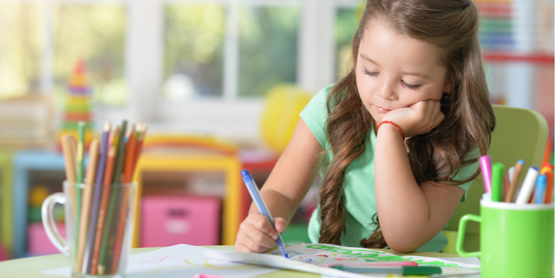 Portrait of happy student girl drawing at home-1