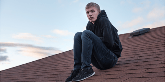 What is self harm_ depressed male teenager sitting on his roof
