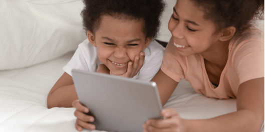 brother and sister watching Ipad together