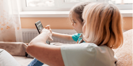 child and grandma on tablet