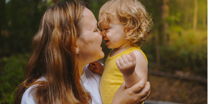 cute blonde toddler and mum having a cuddle