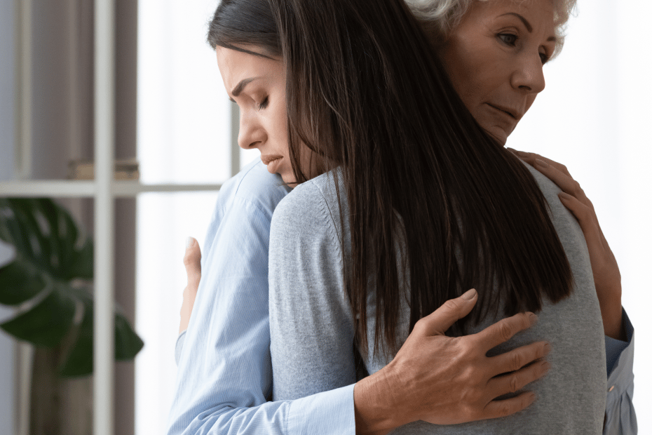grieving girl comforted by her grandmother