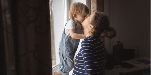 young mother kissing toddler son