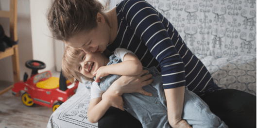 young mum and toddler cuddling